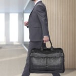 side view. two young businessmen stepping forward.